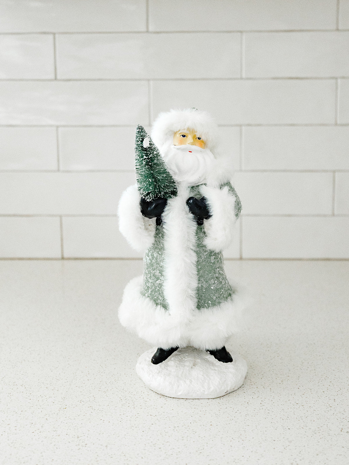 Green Santa Holding a Tree